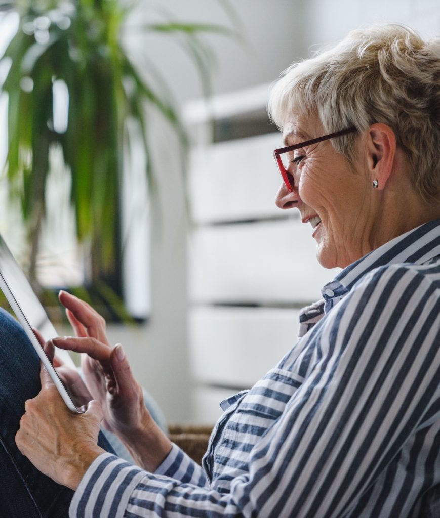 Older woman using a tablet at home