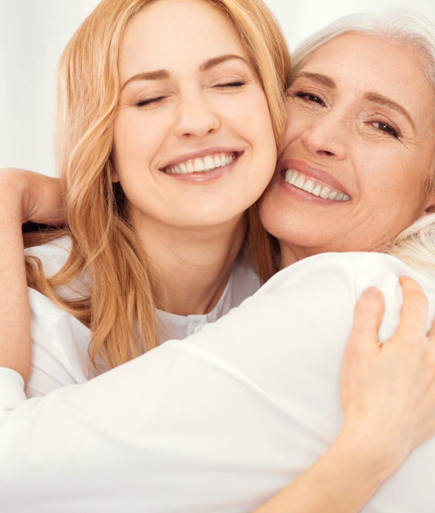Older mom hugging her daughter