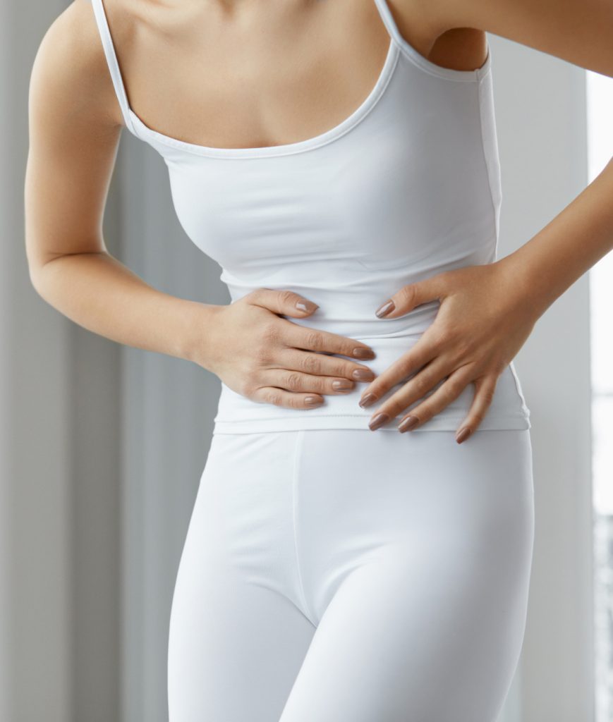 Woman clutching her abdominal area