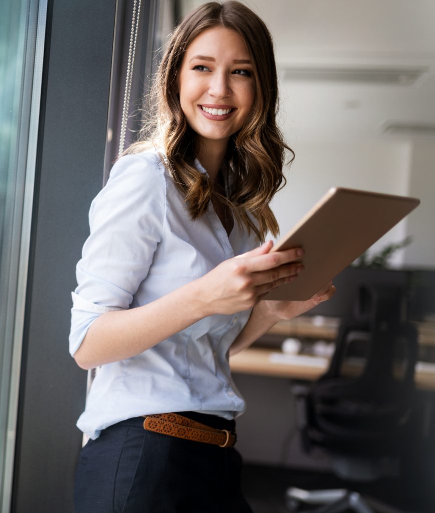 Happy woman holding a tablet